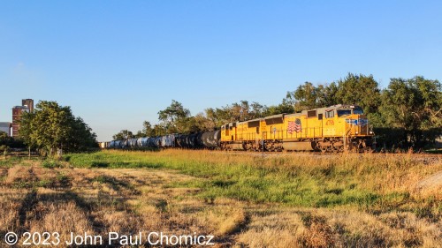 This mixed-freight train had either just arrived or was doubling up the train because it stopped and shoved back into the UP yard in Enid, OK. The historic ADM grain silos rise up in the background on the left of this photo.