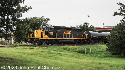 This Stillwater Central Railroad Local is powered by WAMX #: 4142 an SD40-2 that was built for the BN. Here, it peaks through the trees as it drills the SLWC Yard in Oklahoma City, OK.