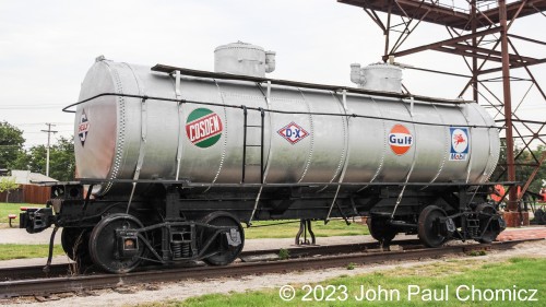 This double-domed tank car was built in 1917 and was used to carry the oil found during the oil-boom in Oklahoma in the early 1900's. The logos of all the oil companies involved in the oil-boom were hand-painted on the sides of the car. The only exception is the logo of the company that helped restore the car and move it to its current location at the Historic Route 66 Village in Tulsa, OK.