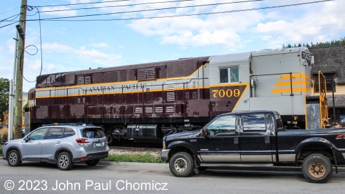 The Canadian Pacific #: 7009 sits on display in front of the Nelson Visitor's Center in Nelson, British Columbia, Canada. The unit is displayed in the middle of a parking area and is very difficult to photo without obstructions.