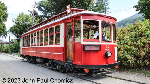 After going for an enjoyable ride on the streetcar, I set up to get a photo of it as it passed by on the second round-trip of the day. Joe is now serving as the engineer as Jean switched ends and is now serving as conductor. The trip is approximately 3/4's of a mile and runs along Rosary Lakeside Park in Nelson, British Columbia, Canada. I'm proud to say that the Streetcar was built in Elizabeth, NJ by the Stepheson Car Company in 1906. After its service ended in 1949, it was used as a kennel and for other odd functions before being purchased in 1982 and restored. The current operation began in 1992 after the Canadian Pacific Railway donated the track on which it currently operates. It is an all-volunteer group that maintains and operates the car, and it is an enjoyable experience worth doing just to meet these proud people that keep it alive.