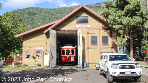 I arrived at the Nelson Electric Tramway Society Museum just before the start of streetcar operations for the day. Here, Streetcar #: 23 peaks out of the barn doors as it is inspected prior to running. In the cab, you can see, "Jean", one member of a crew of two that operates the streetcar. In a little bit, she will give me a shout and I will board for the first trip of the day. The trip is approximately 3/4's of a mile long and has a loop at both ends to allow continuous running.