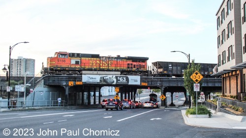 The slightly charred BNSF #: 5156 idles, with a mixed-freight, on the overpass over South Division Street in Spokane, WA.