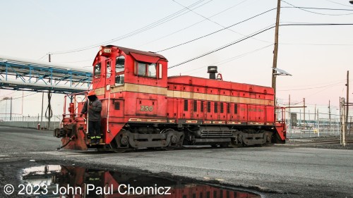 After dropping off at Yard #: 8 the "Red Baron" pulls out of the yard for one last time as the guard closes the gate behind the unit. Although the unit will pass me again as it comes back across the road to get back to the Constable Hook Lead to head back into the main part of the terminal, the light was too low for the camera and those shots came out terrible. Hopefully, this won't be the last time I see the EJRR at this location and this area of operations won't shut down. But, this is Bayonne.