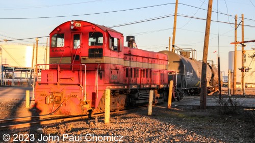 The sun position made it a bit hard not to get my shadow in this pic of the "Red Baron" as it crosses the Hook Road to spot cars in Yard #: 8. Even though the light is low and at the limit of my camera, I would like to document the train in this area as train operations in this area might be gone, soon. According to certain sources, IMTT might be selling off this part of the terminal on the east side of the Hook Road for other development. This may or may not include the current railroad infrastructure.