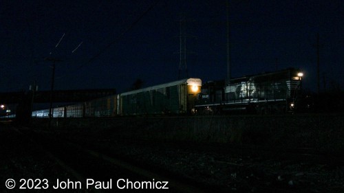 It's not quite late, yet, but the early darkness on this mid-November evening makes it seem like the dead of the night. With no light, now, the second trick switcher pulls out a string of autoracks from the Little Ferry Auto Terminal that's actually in Ridgefield, NJ. I was considering not posting this as I had to light it up, quite a bit, and it's still very dark/grainy but I like the headlight reflection off of the autoracks and some other nice details.