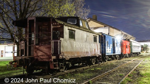 At the end of the display line is the Pennsy #: 478064 at the Kutztown Station in Kutztown, PA. It sits alongside a Conrail Caboose, and Allentown & Auburn Caboose, and Allentown & Auburn passenger car.