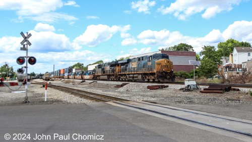 The first few doublestack cars, on this southbound, are filled with Amazon, "Smile", containers. The train is crossing Mount Vernon Street in Ridgefield Park, NJ.