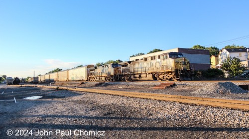 A "Bright Future" livery on this CSX unit seems a little too bright to appreciate as it leads a southbound autorack through Ridgefield Park, NJ in the late evening sun.