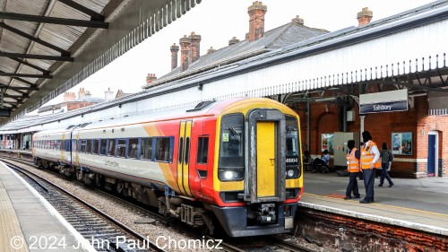 This South Western Railway train is a British Rail Class 158 Express Sprinter diesel MU set that is waiting to depart Salisbury Station to points west. The crew is on the platform awaiting departure time.