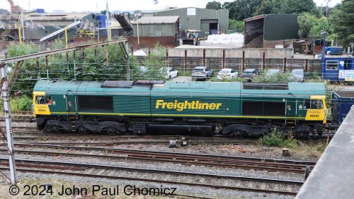 A close-up view of the Freightliner #: 66564 British Rail Class 66 as it shoves back into the yard to double-up its train.