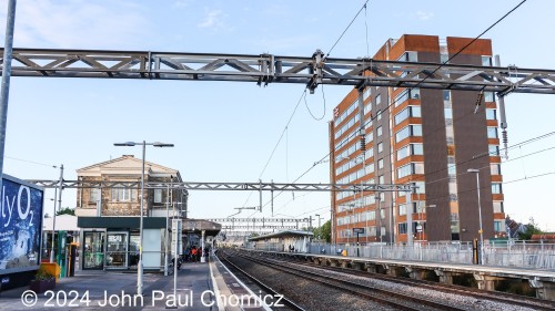 The trackside view of Swindon Station shows the boarded-up administration building and the less modern-looking building in the center of the platform.